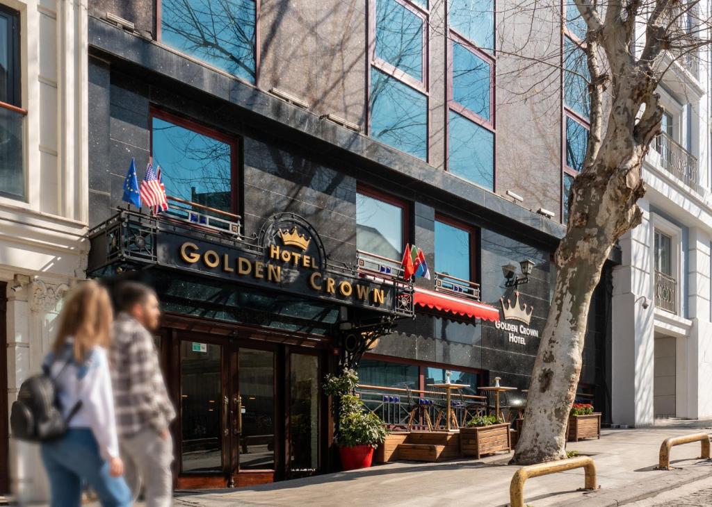 people walking in front of a colgate building at Golden Crown Hotel in Istanbul