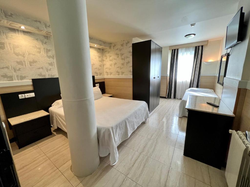 a hotel room with a bed and a sink at Hotel Don Diego in Suances