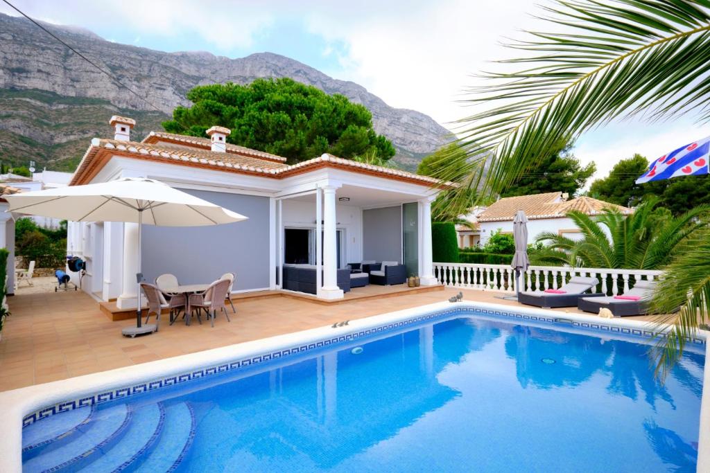 a villa with a swimming pool and a house at Casa Harmony in Denia