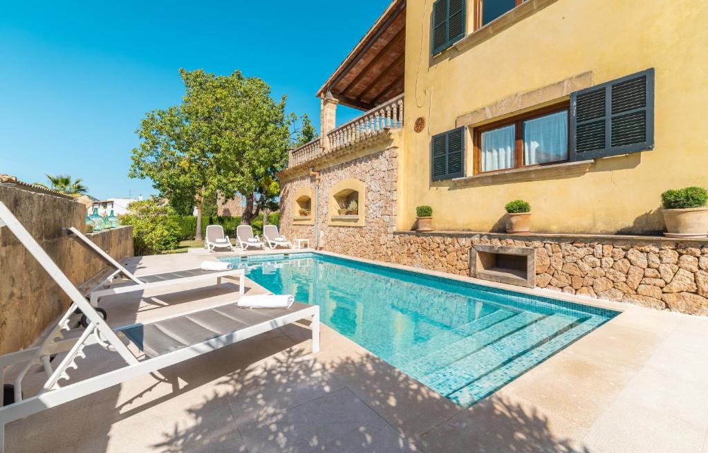 a villa with a swimming pool and a house at Son Apiana in Mancor del Valle