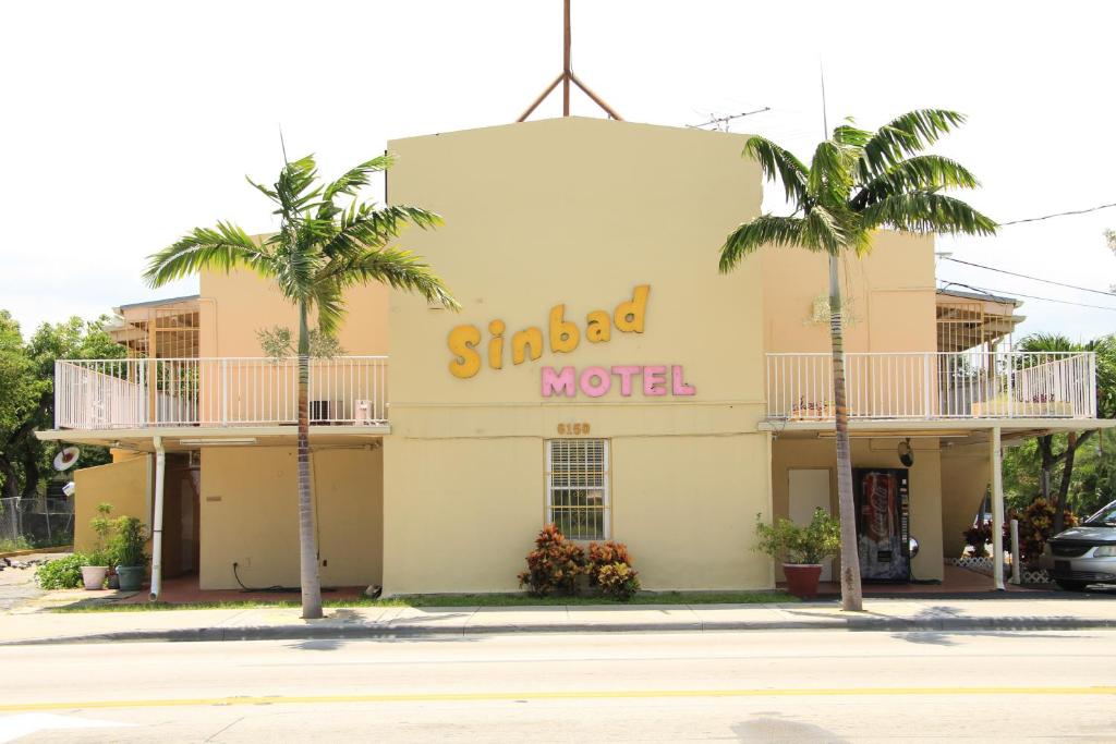 a large building with a sign on the side of it at Sinbad Motel in Miami