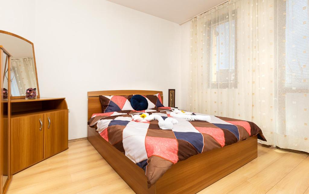 a bedroom with a bed with a dresser and a mirror at Lovely 1BD Apartment close to the Summer Theatre in Plovdiv