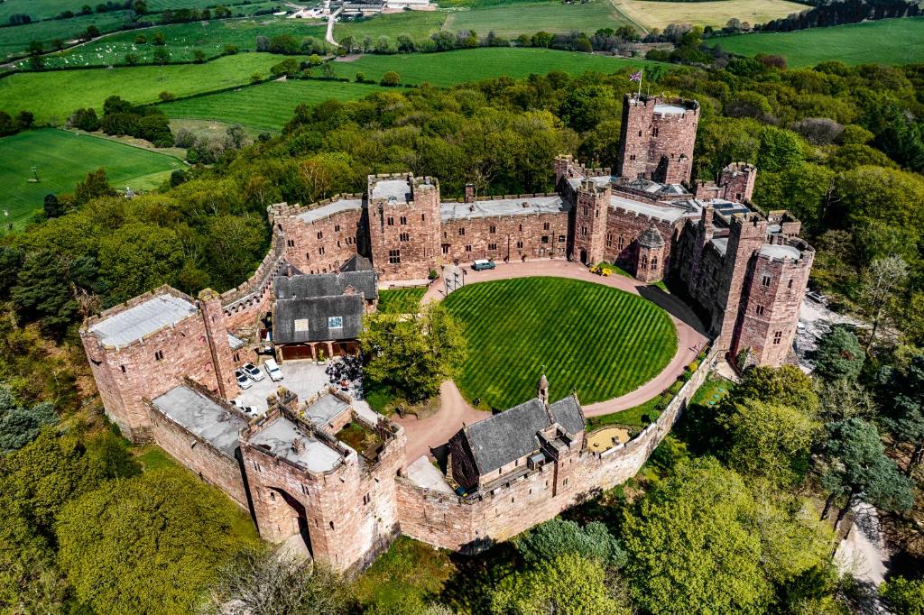 an aerial view of a castle with a baseball field at Peckforton Castle in Tarporley