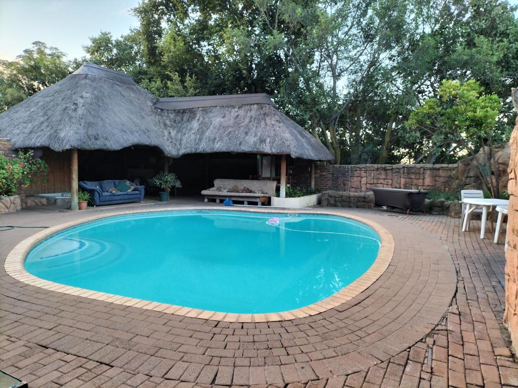 a swimming pool with a gazebo at Botties Shemah in Pretoria
