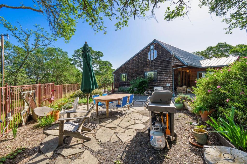 a patio with a table and a grill and a house at Healdsburg Home with Magnificent Vineyard View home in Healdsburg
