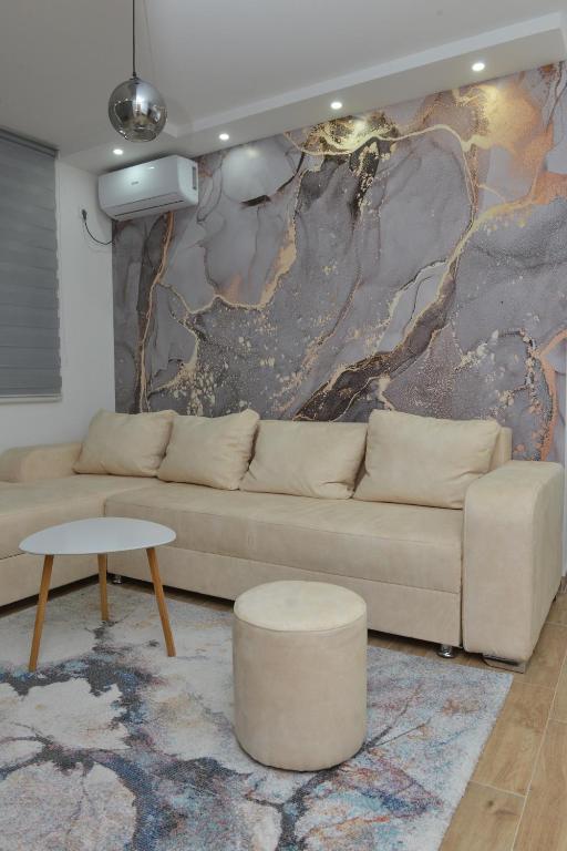 a living room with a couch and a table at Apartman Martenovic 2 in Vrnjačka Banja
