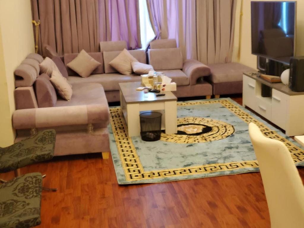 a living room with a couch and a table at Lemas 901 in Ajman 