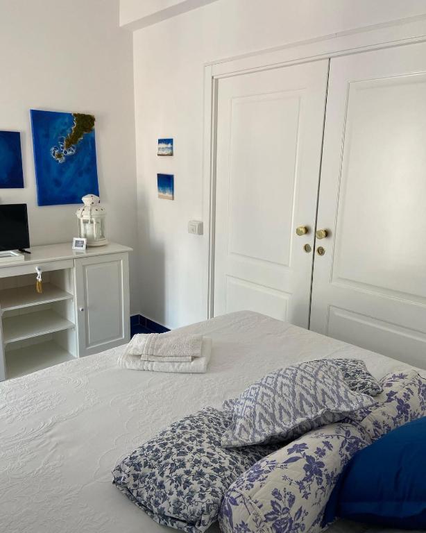a bedroom with a bed with a pillow on it at Casa Blu Cobalto in Maiori