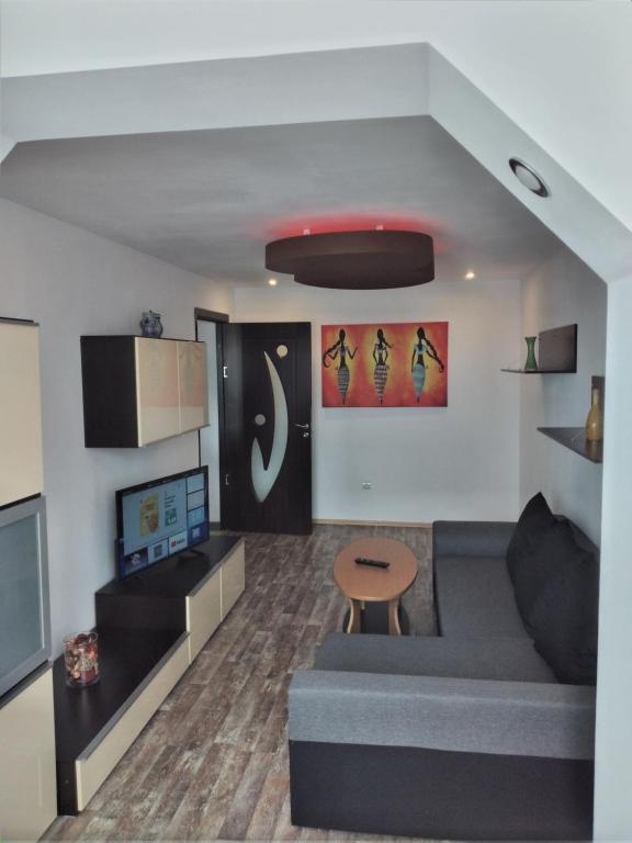 a living room with a couch and a table at ZORILOR IMOB in Braşov
