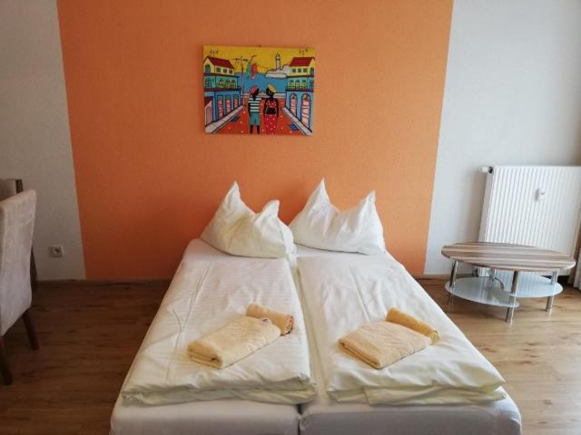 a white bed with two pillows on top of it at Stylish warm apartment in Villach
