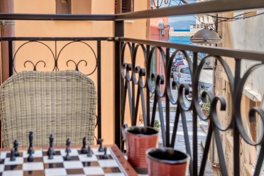 a chess board on a balcony with a chair at Casa Livieres in Chania Town