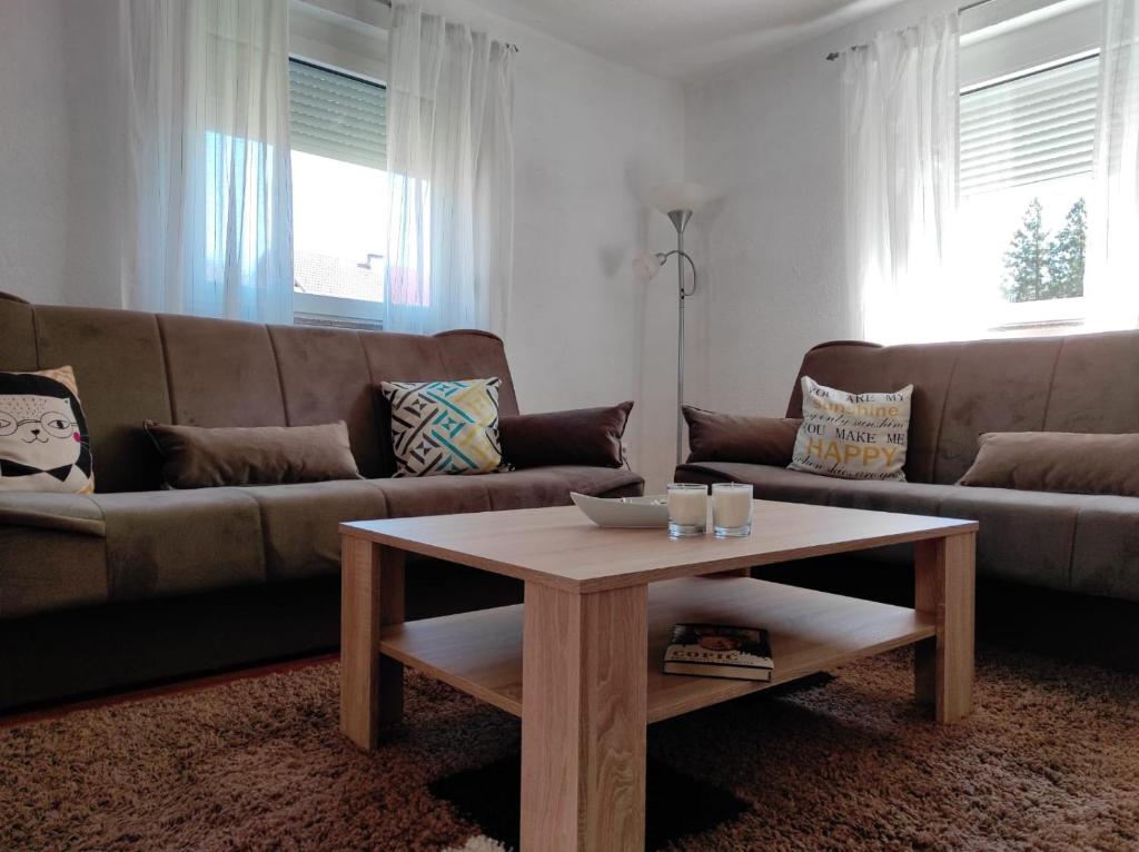 a living room with a couch and a coffee table at Apartman "Like at home" Jajce in Jajce