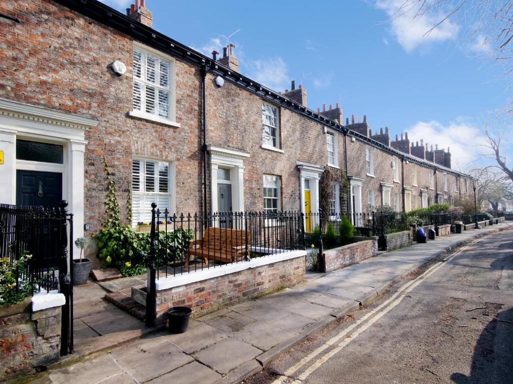 a row of brick houses on a street at Bar Wall Cottage-City Wall Views-sleeps 5 in York