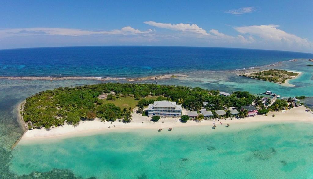 an island in the ocean with people on a beach at Graham's Place in Guanaja