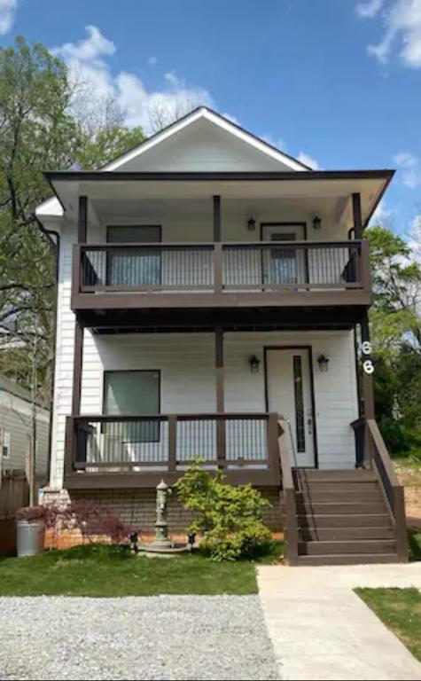 Hotel Atlanta Unit 1 Room 3 - Cheerful Private Bedroom & Bathroom, a large white house with a balcony and stairs at Atlanta Unit 1 Room 3 - Cheerful Private Bedroom & Bathroom in Atlanta
