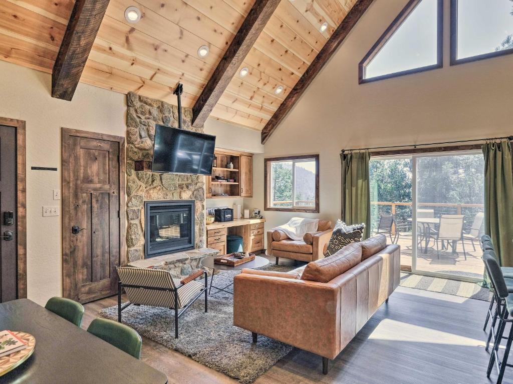 a living room with a couch and a fireplace at Luxury Retreat Custom Mi-Wuk Village Cabin! in Mi-Wuk Village