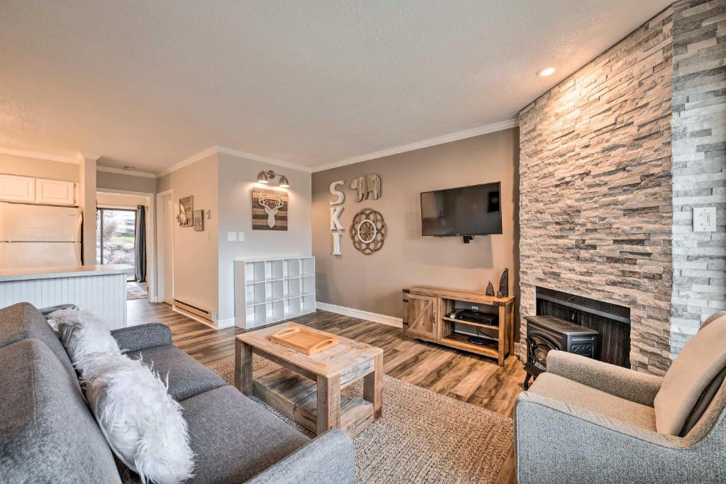 a living room with a couch and a fireplace at Chic Eden Condo with Pool Access Less Than 5 Mi to Ski! in Eden