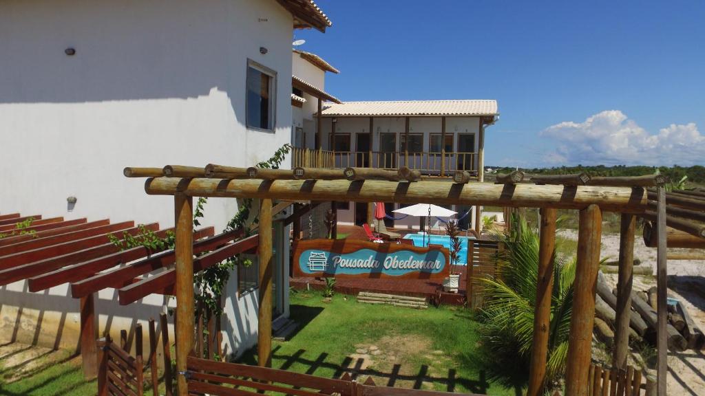 a view of a house with a wooden deck at Pousada Obedemar - Taipu de fora, Barra Grande, Ba in Barra Grande