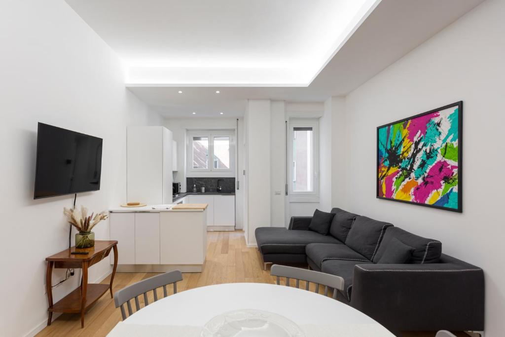a living room with a couch and a table at Naviglio Dream - 2 bedrooms 2 bathrooms in Milan