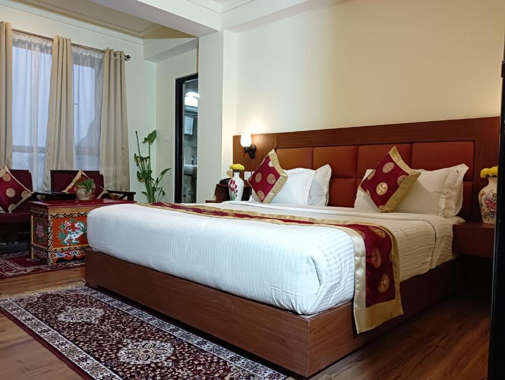 a bedroom with a large bed in a room at Hotel Zingkham Residency in Gangtok