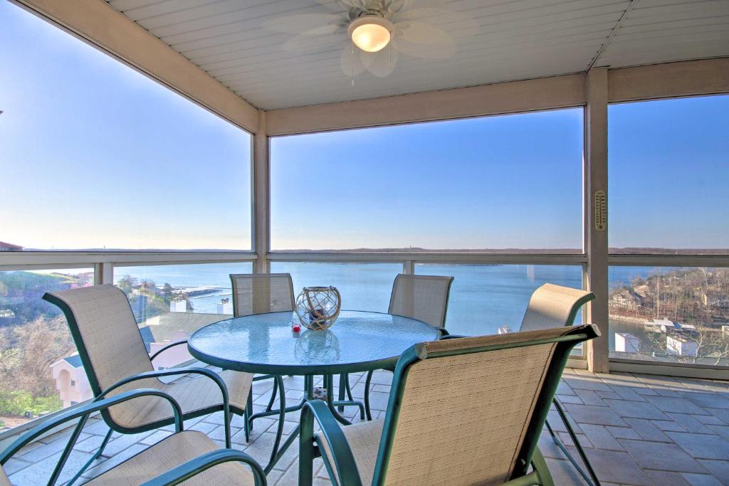 a table and chairs on a balcony with a view of the ocean at Lake Ozark Condo with Balcony and Water Views! in Lake Ozark