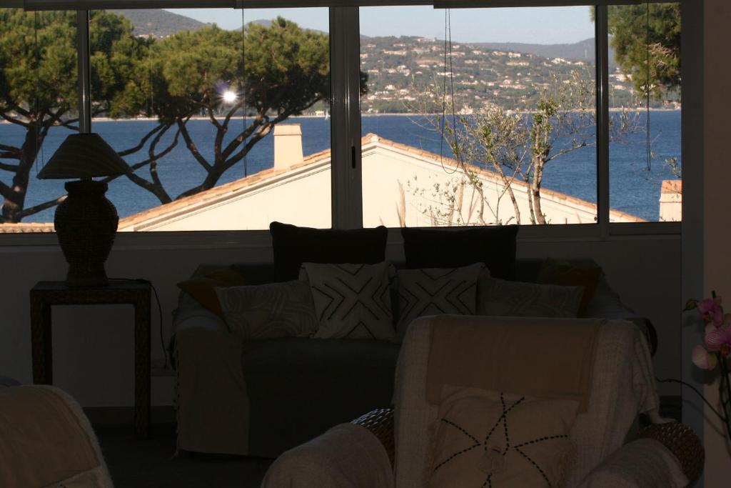 a living room with a couch and a view of the water at Hotel Villa Maya in Saint-Tropez