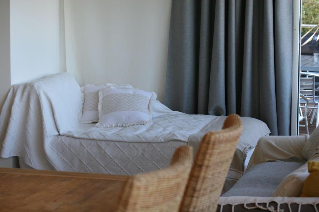 a bedroom with a bed in a room with a window at Hotel Villa Maya in Saint-Tropez