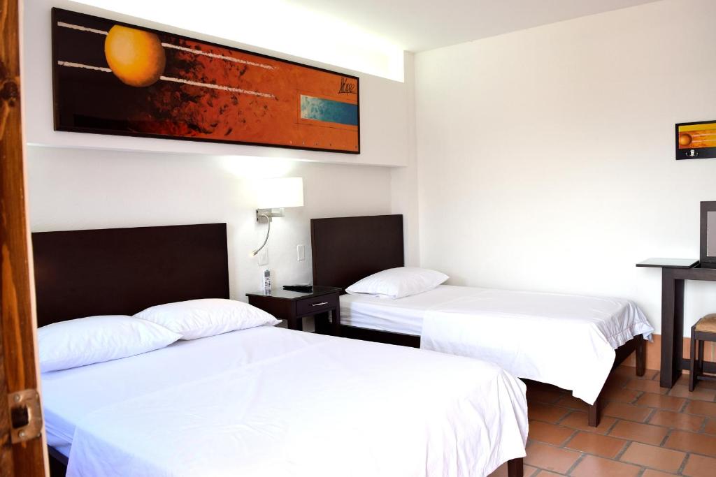 Postel nebo postele na pokoji v ubytování Chrisban Hotel Boutique