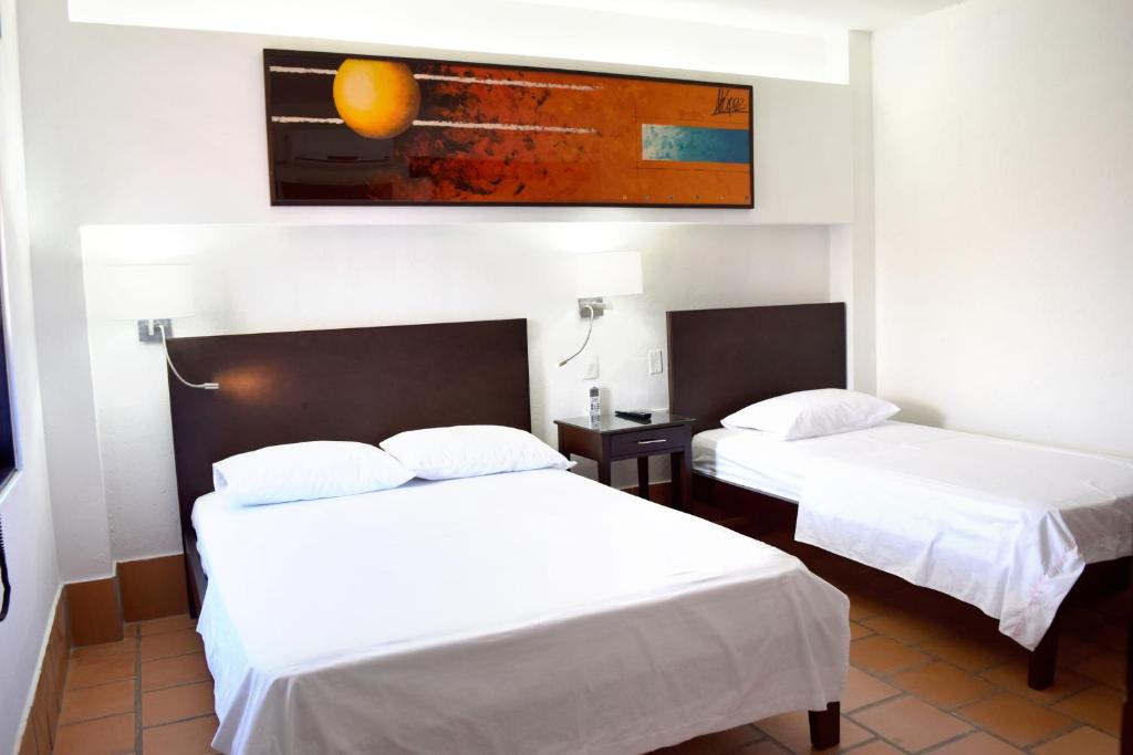 Postel nebo postele na pokoji v ubytování Chrisban Hotel Boutique