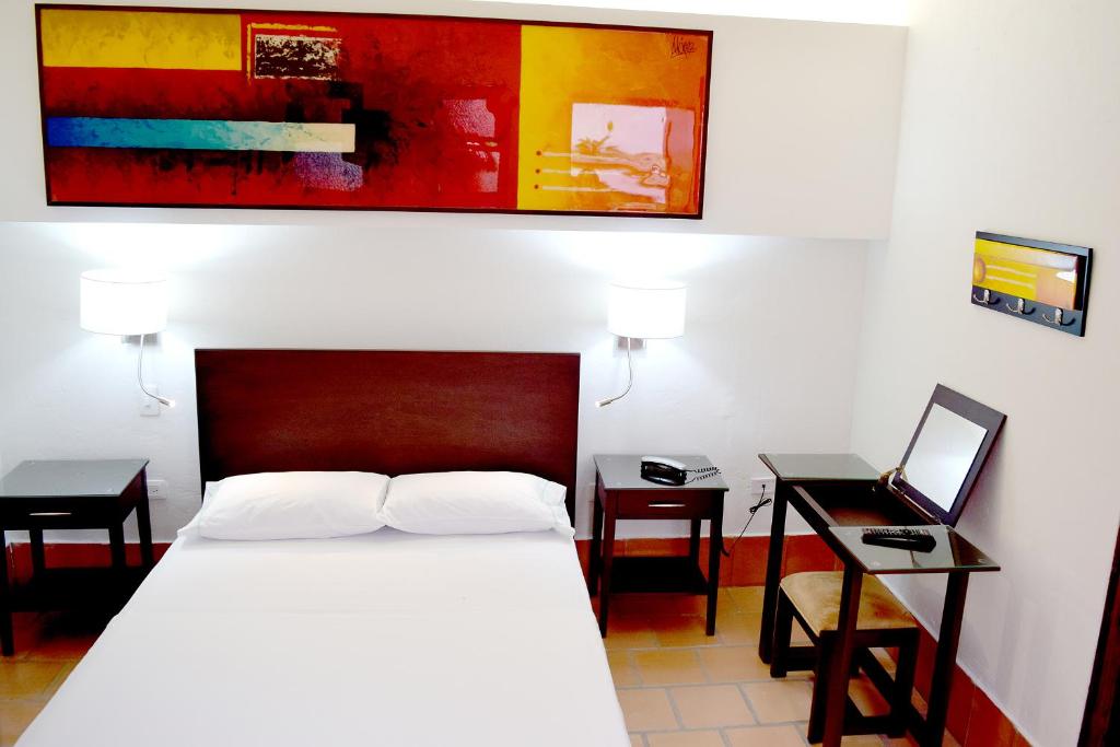 Postel nebo postele na pokoji v ubytování Chrisban Hotel Boutique