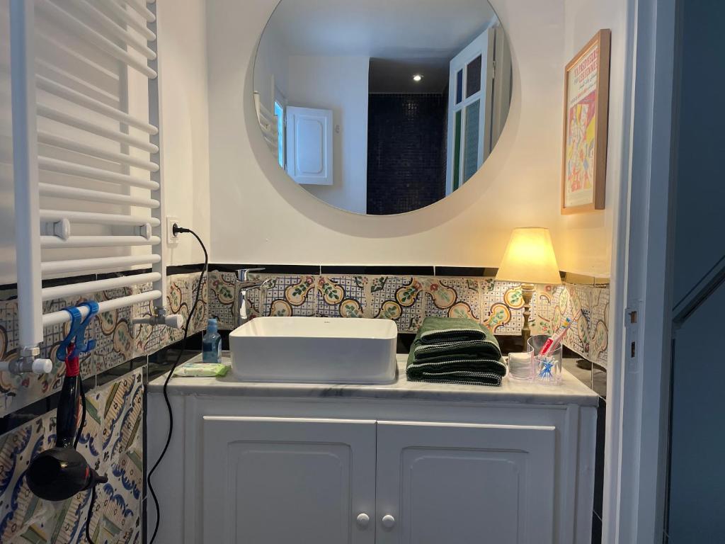 a bathroom with a sink and a mirror at Chez ADAC in Sidi Bou Saïd