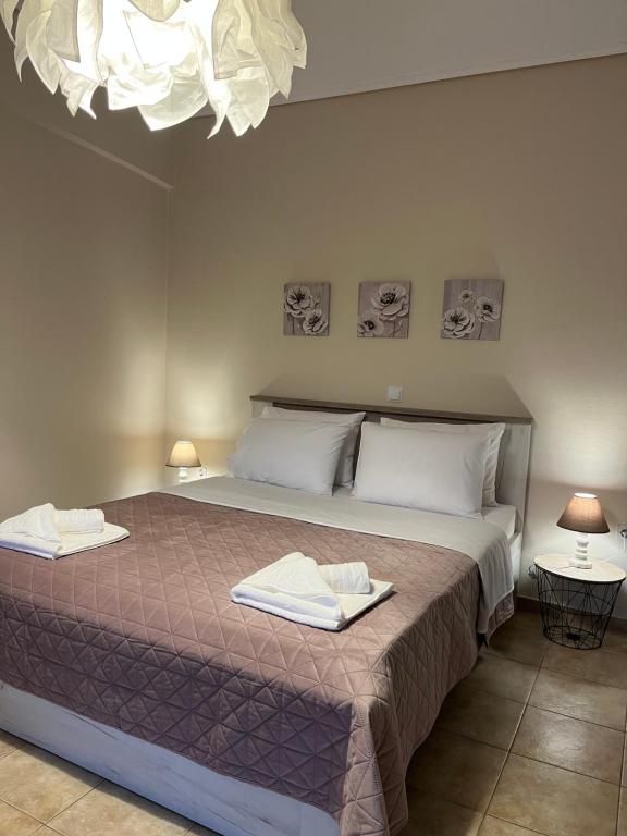 a bedroom with a large bed with two towels on it at Filanthis inn in Kalamata