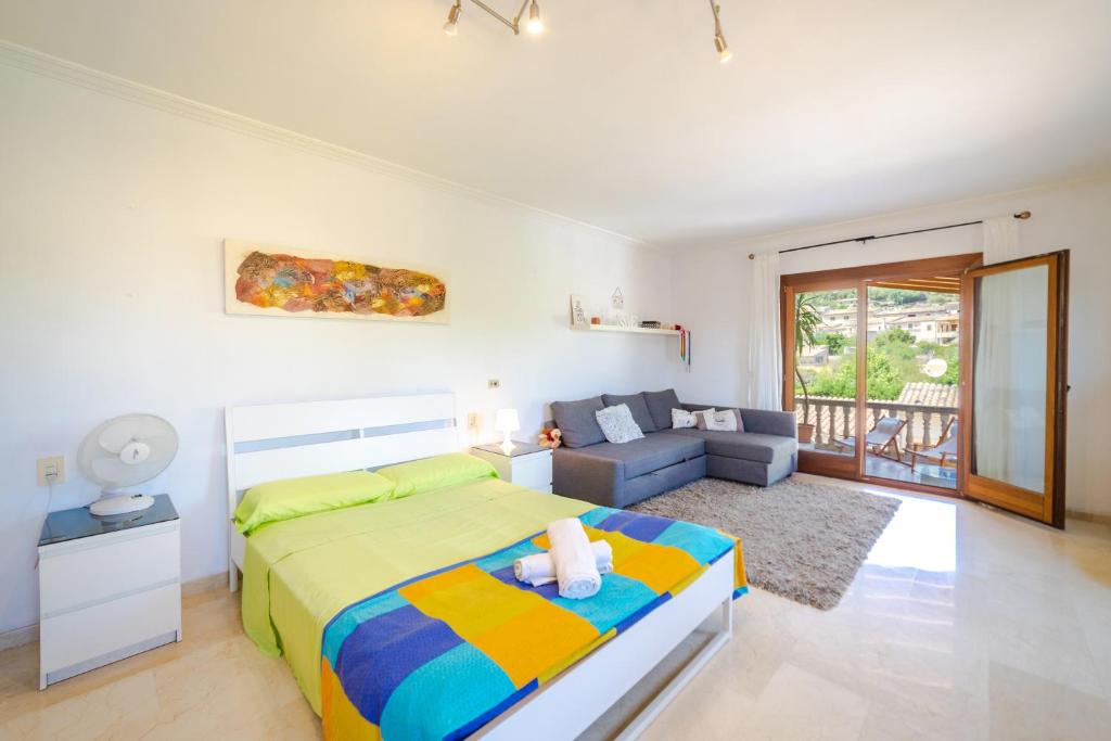 a bedroom with a bed and a couch at Son Apiana in Mancor del Valle