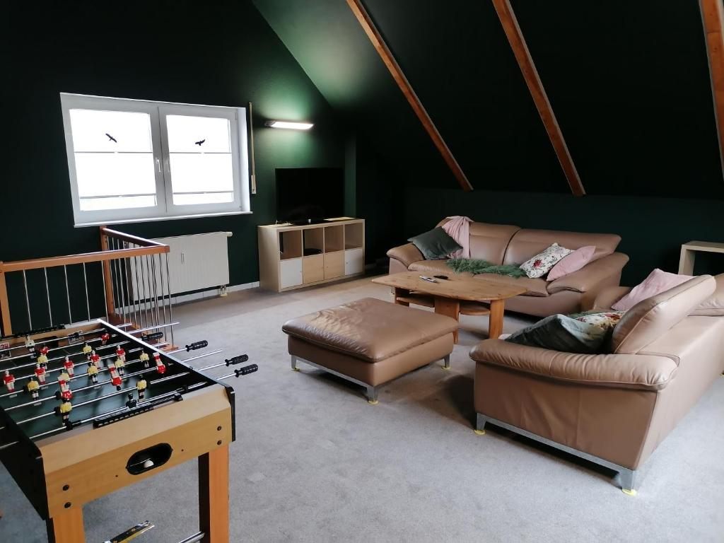 a living room with a table and a chess board at Ferienwohnung Auszeit in Kalletal