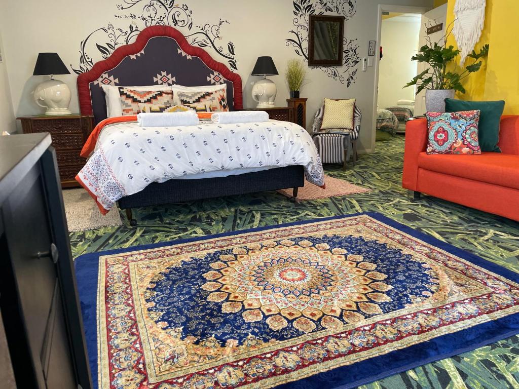 a bedroom with a large bed and a rug at Highlands Riad in Moss Vale