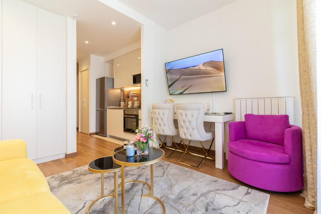 a living room with a purple chair and a table at Belgrade Waterfront Studio Apartment-Supertwins in Sajmište