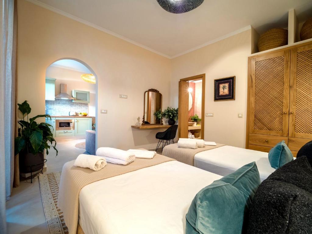 a room with two beds and a kitchen at Carmena Residence in Skala Kefalonias