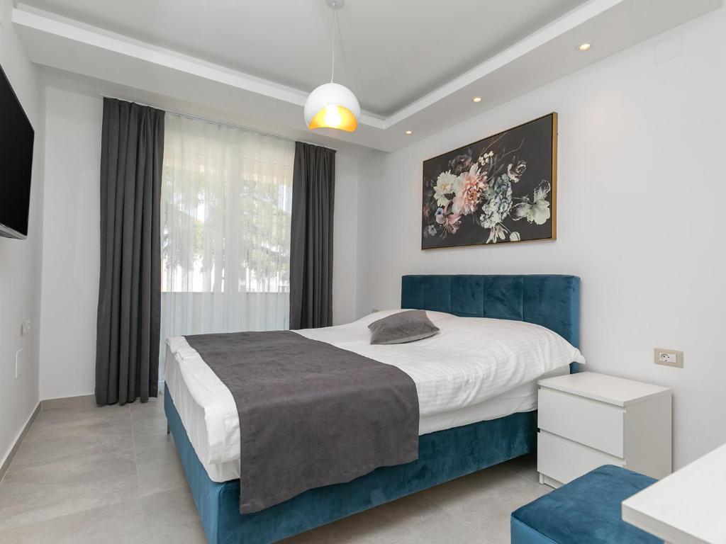 Łóżko lub łóżka w pokoju w obiekcie Nadija Apartmani
