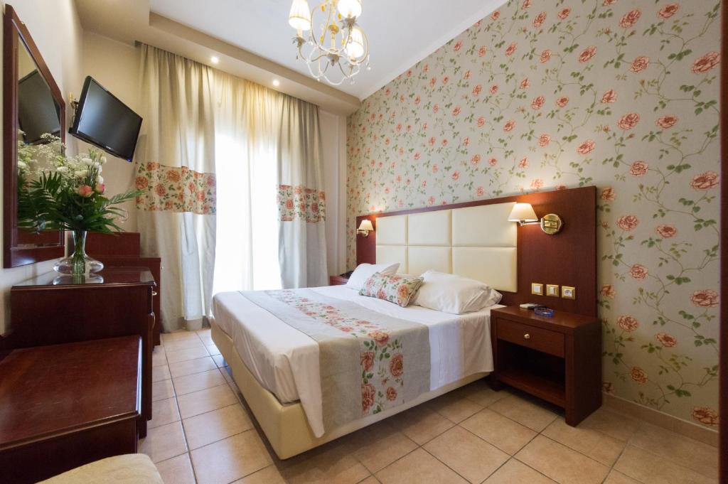 Postel nebo postele na pokoji v ubytování Olympic Hotel