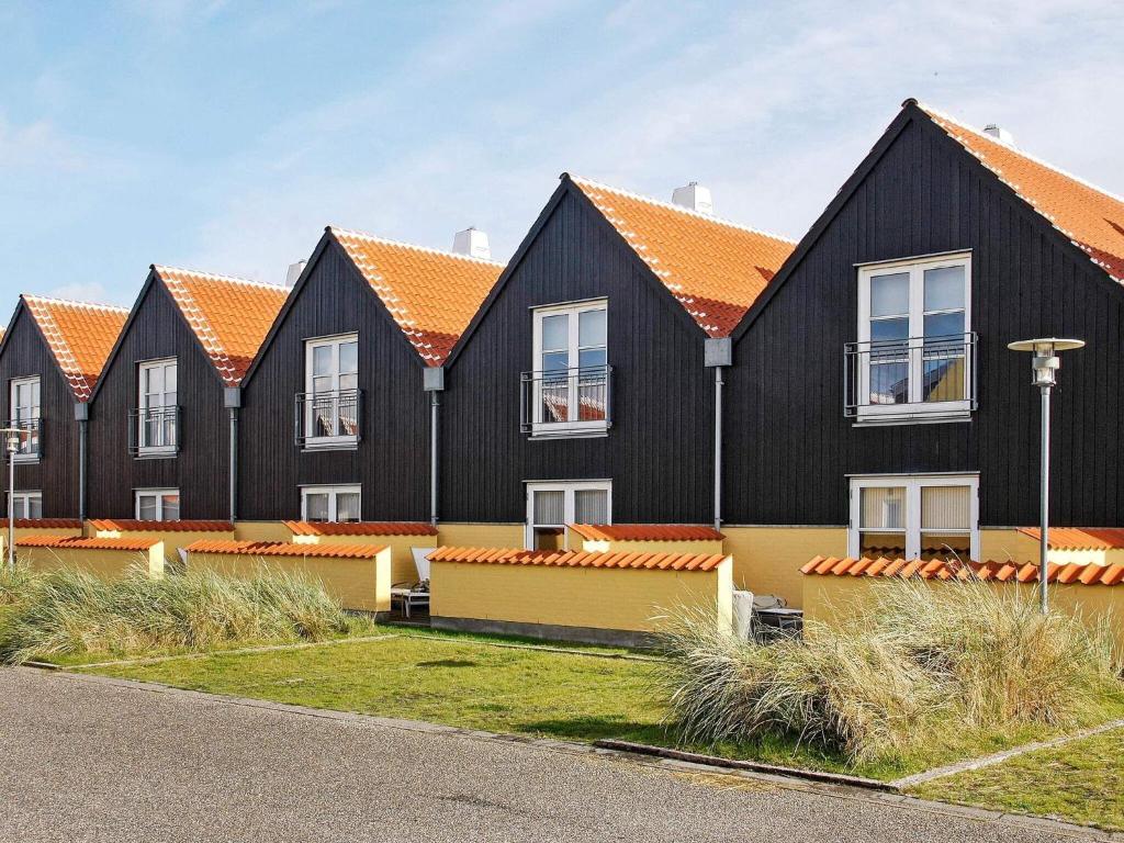 a row of houses with orange roofs at Apartment Skagen XIX in Skagen