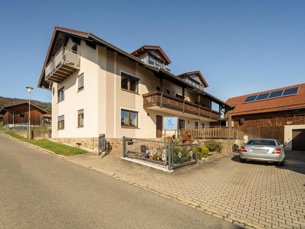 a house with a car parked in front of it at Cosy and child-friendly holiday home in the Bavarian Forest in Gleißenberg