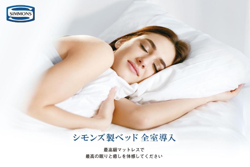 Postel nebo postele na pokoji v ubytování ZONK HOTEL Hakata