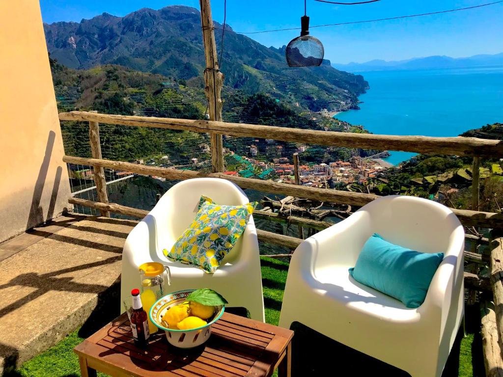 a balcony with two chairs and a table with a view at The Hidden Garden in Ravello