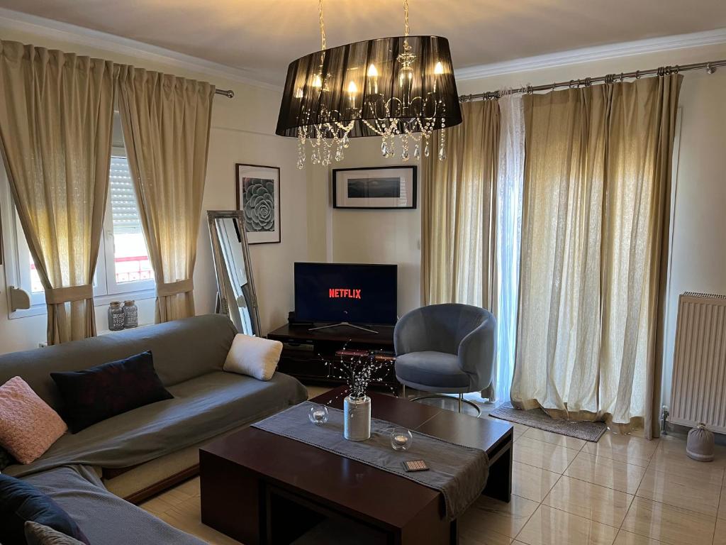 a living room with a couch and a table at Apartament in Thessaloniki in Paliókastron