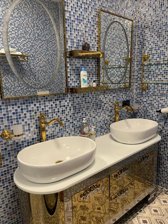a bathroom with two sinks and mirrors on a counter at Apartments Villa Isabella in Opatija