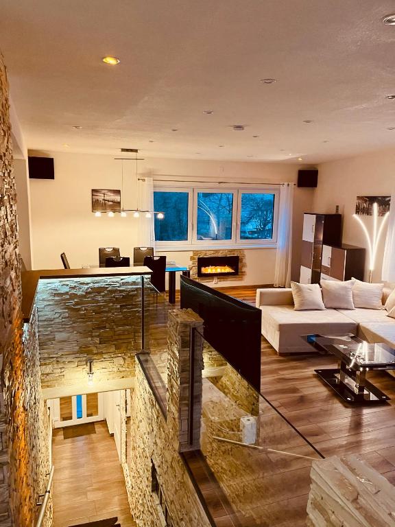 a large living room with a large stone fireplace at Luxus Resort - Zupko in Fiľakovo