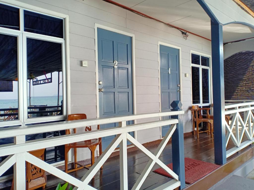 a house with a balcony with a view of the ocean at Suhaila Palace in Perhentian Islands