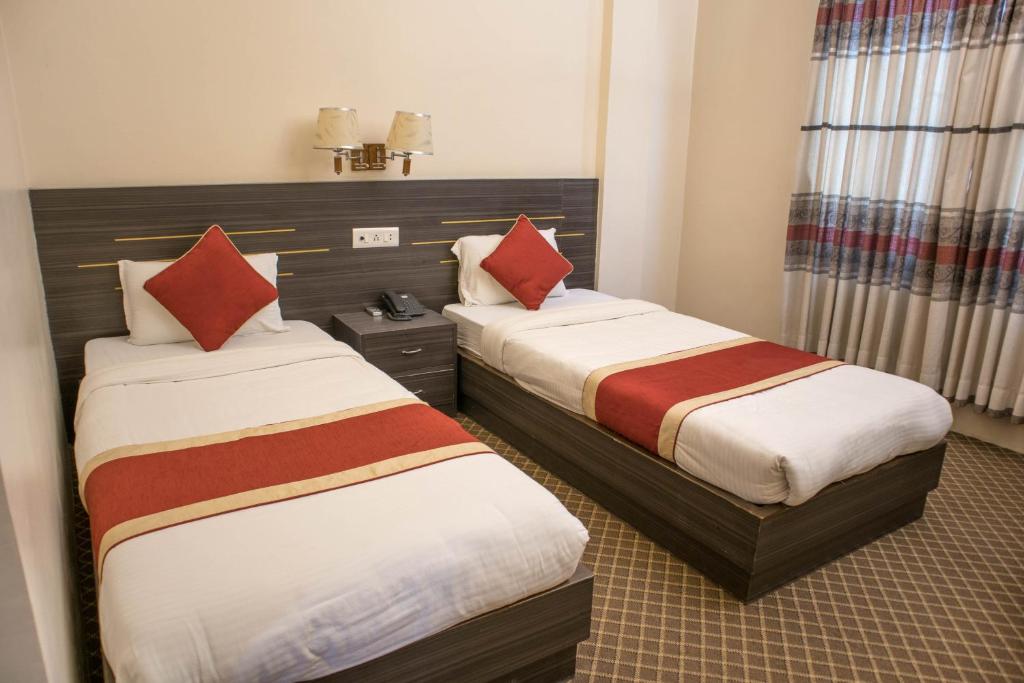 Postel nebo postele na pokoji v ubytování Mirage Inn