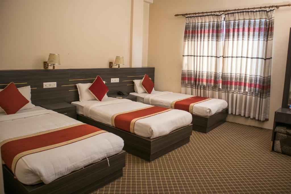 Postel nebo postele na pokoji v ubytování Mirage Inn