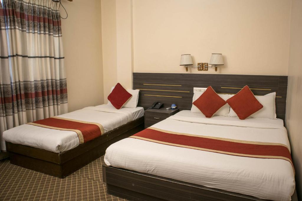 Postel nebo postele na pokoji v ubytování Mirage Inn